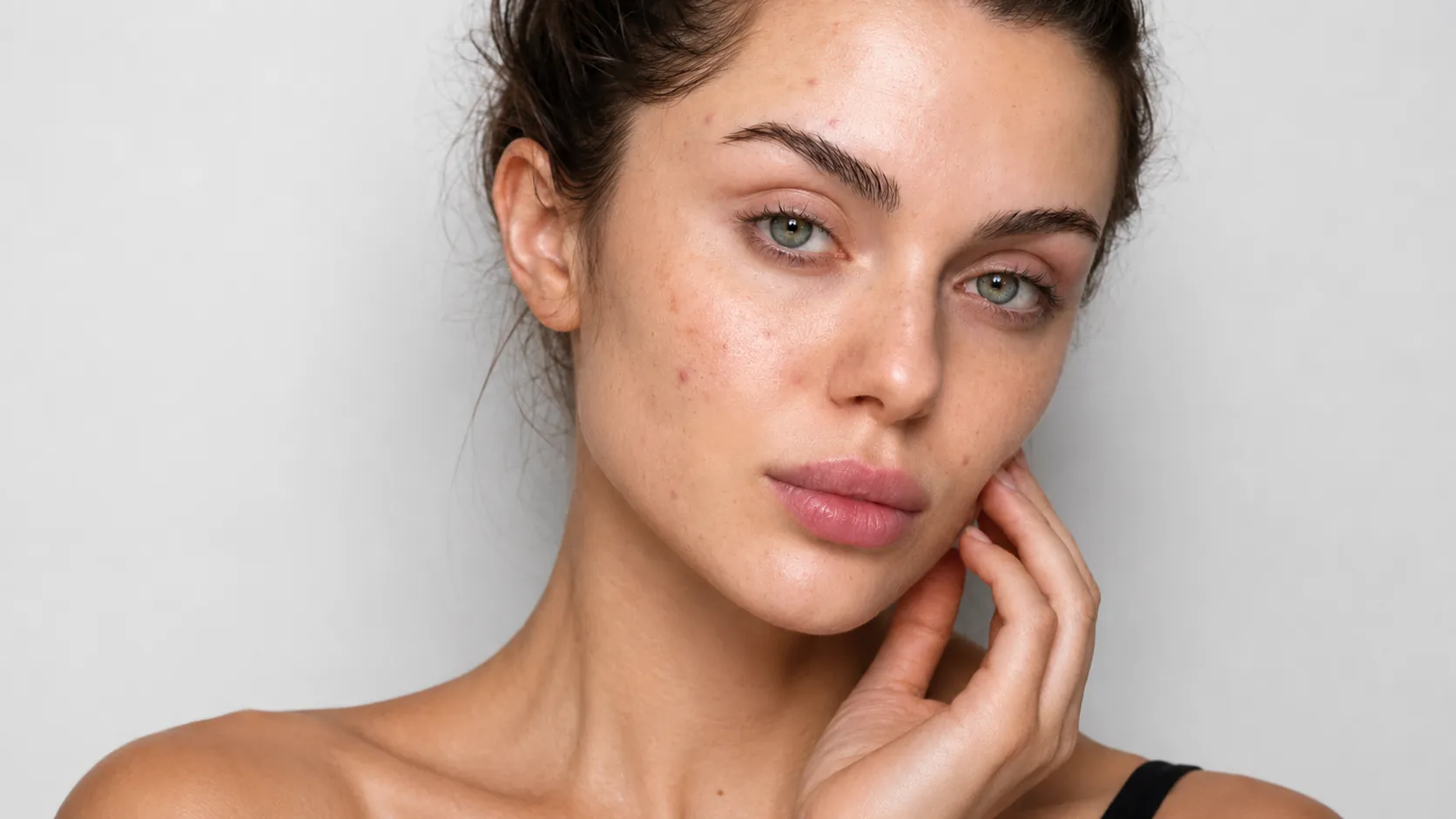 Close-up of a woman's cheek before using Glo Key, showing dull, uneven skin texture and visible fine lines